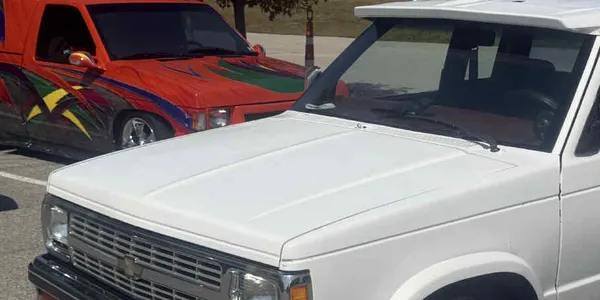 Customized mini-trucks parked together at an event